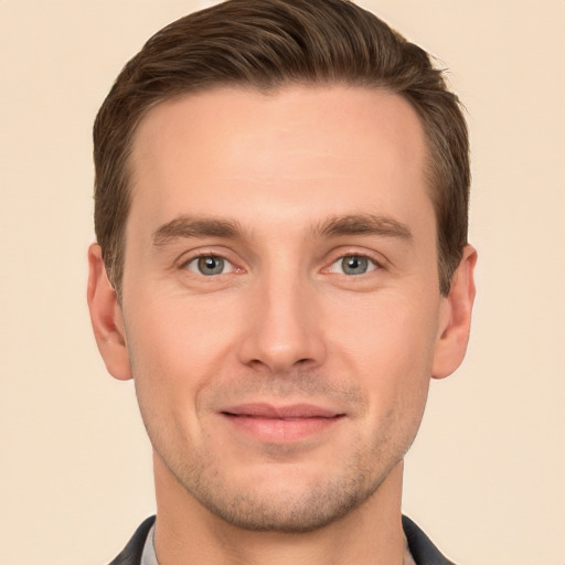 Joyful white young-adult male with short  brown hair and grey eyes