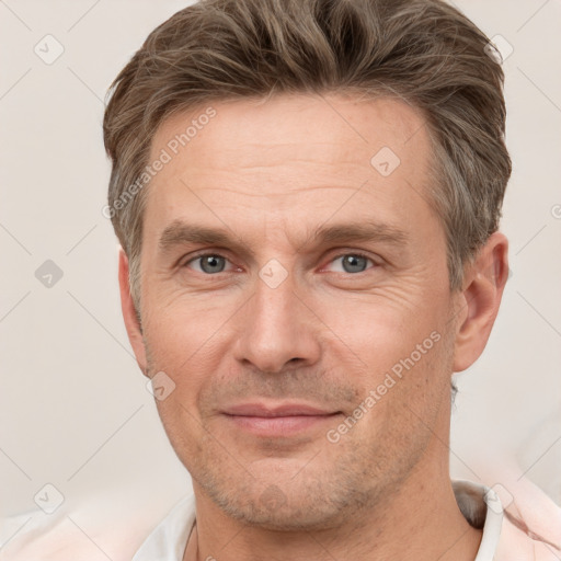 Joyful white adult male with short  brown hair and grey eyes