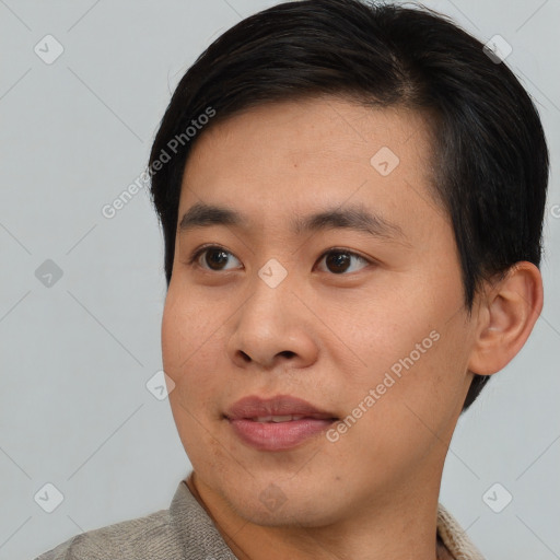 Joyful asian young-adult male with short  black hair and brown eyes