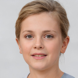 Joyful white child female with medium  brown hair and grey eyes