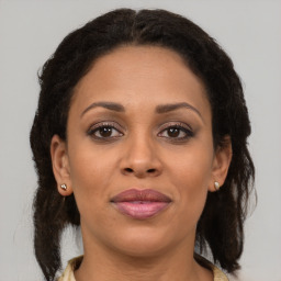Joyful latino young-adult female with medium  brown hair and brown eyes