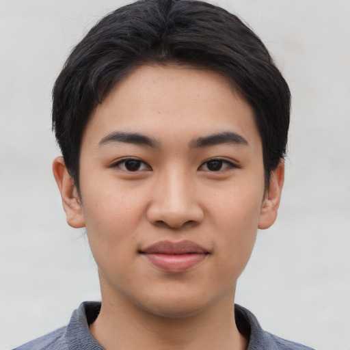 Joyful asian young-adult male with short  black hair and brown eyes