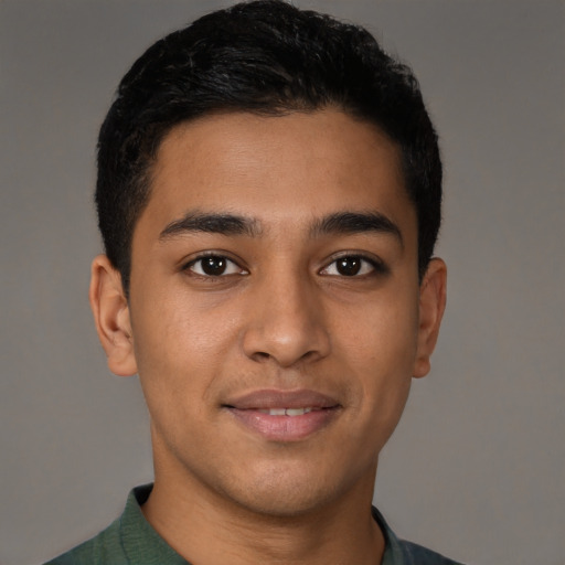 Joyful latino young-adult male with short  brown hair and brown eyes