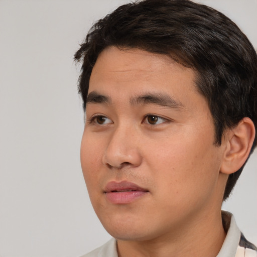 Joyful white young-adult male with short  black hair and brown eyes