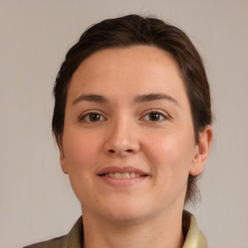 Joyful white young-adult female with medium  brown hair and grey eyes