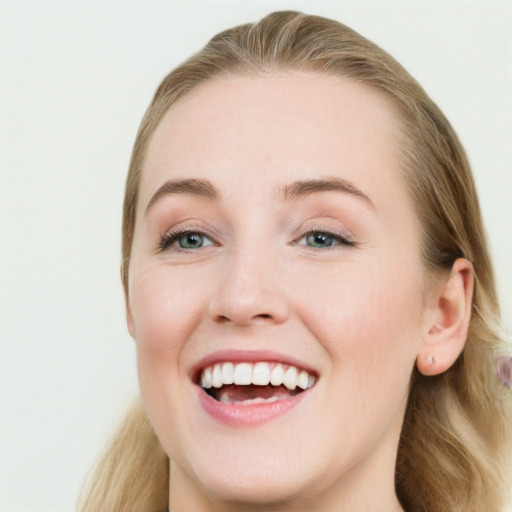 Joyful white young-adult female with long  brown hair and blue eyes