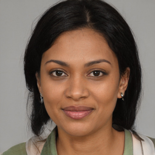 Joyful black young-adult female with medium  black hair and brown eyes