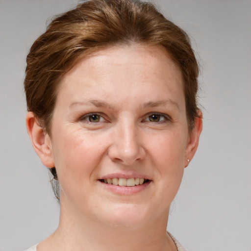 Joyful white adult female with short  brown hair and grey eyes