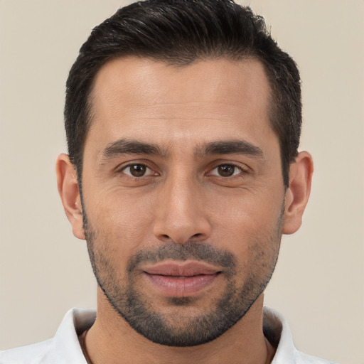 Joyful white young-adult male with short  black hair and brown eyes