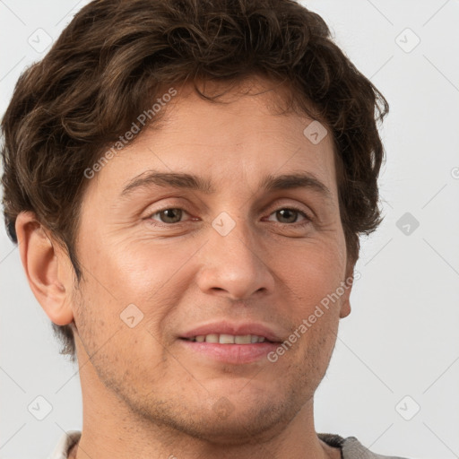 Joyful white adult male with short  brown hair and grey eyes