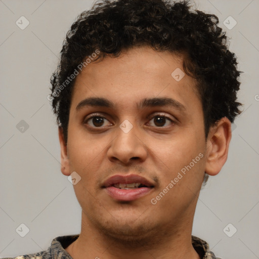 Joyful latino young-adult male with short  brown hair and brown eyes