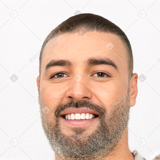 Joyful white young-adult male with short  black hair and brown eyes