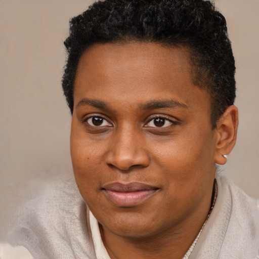 Joyful black young-adult male with short  brown hair and brown eyes