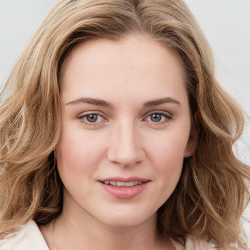 Joyful white young-adult female with medium  brown hair and blue eyes