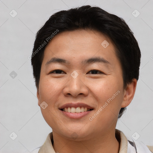 Joyful asian young-adult male with short  brown hair and brown eyes