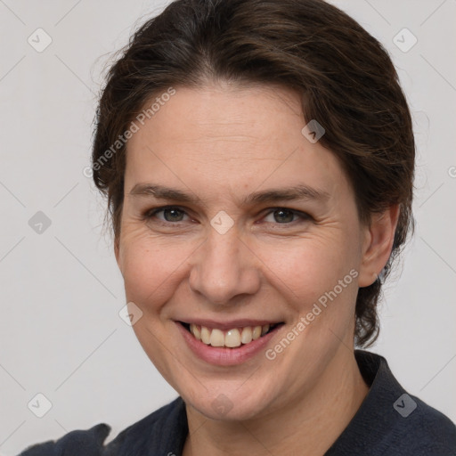 Joyful white adult female with medium  brown hair and grey eyes