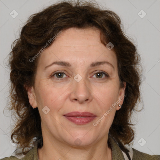 Joyful white adult female with medium  brown hair and blue eyes