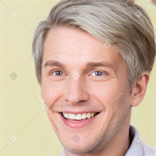 Joyful white adult male with short  brown hair and grey eyes