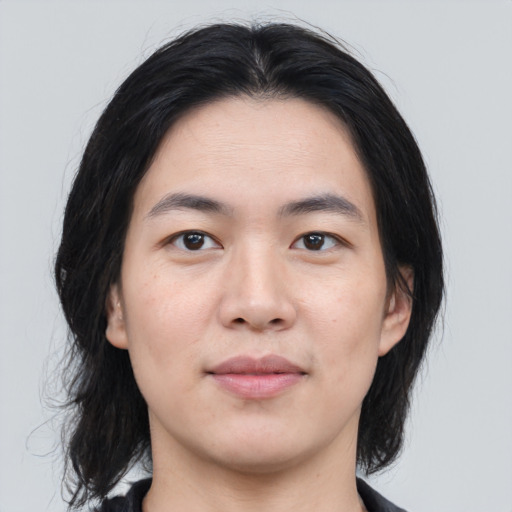 Joyful asian young-adult male with medium  black hair and brown eyes