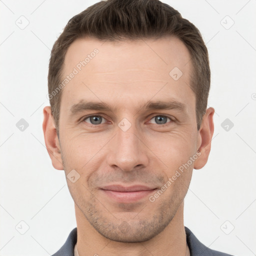 Joyful white young-adult male with short  brown hair and grey eyes