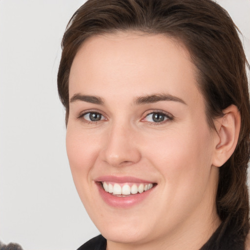 Joyful white young-adult female with medium  brown hair and brown eyes