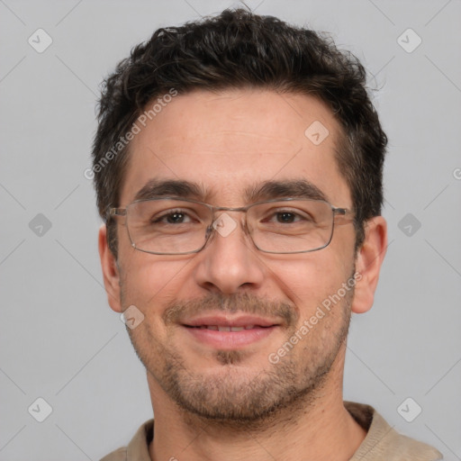 Joyful white adult male with short  black hair and brown eyes