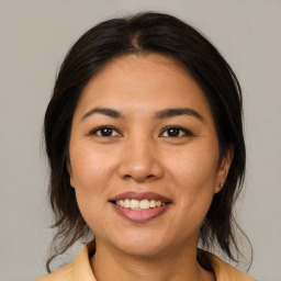 Joyful asian young-adult female with medium  brown hair and brown eyes