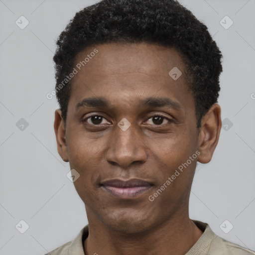 Joyful black young-adult male with short  black hair and brown eyes