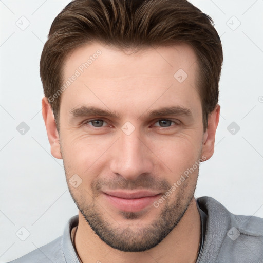 Joyful white young-adult male with short  brown hair and grey eyes