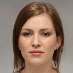 Joyful white young-adult female with medium  brown hair and grey eyes