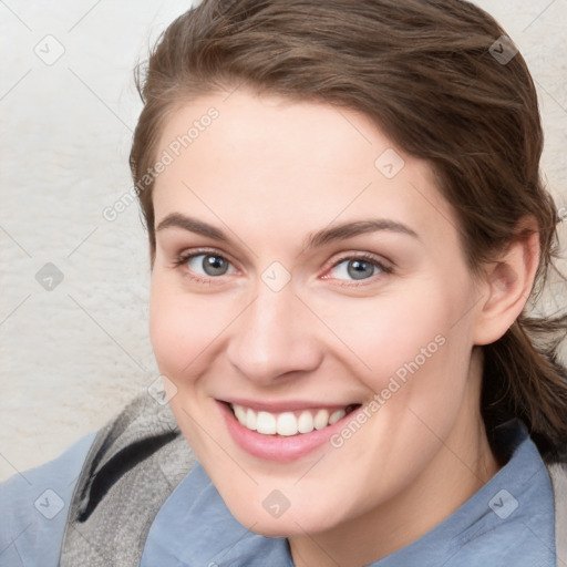 Joyful white young-adult female with medium  brown hair and blue eyes