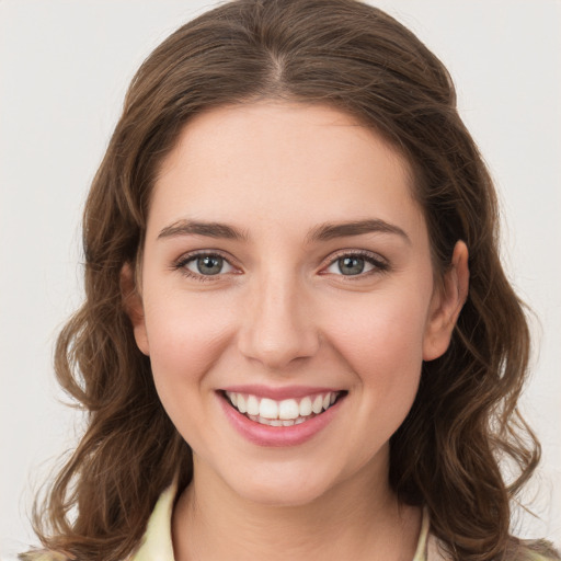 Joyful white young-adult female with medium  brown hair and green eyes