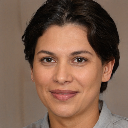 Joyful white adult female with medium  brown hair and brown eyes