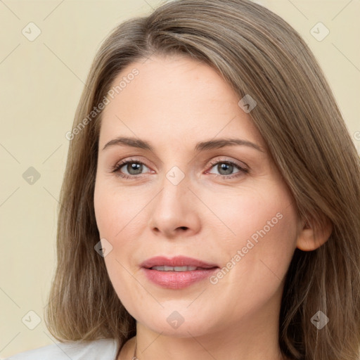 Joyful white young-adult female with long  brown hair and green eyes