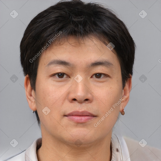 Joyful asian young-adult male with short  brown hair and brown eyes