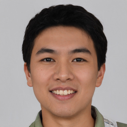 Joyful asian young-adult male with short  black hair and brown eyes