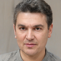 Joyful white adult male with short  brown hair and grey eyes