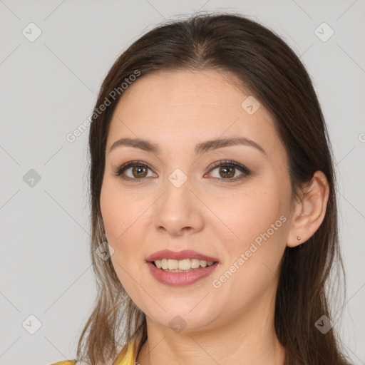 Joyful white young-adult female with long  brown hair and brown eyes