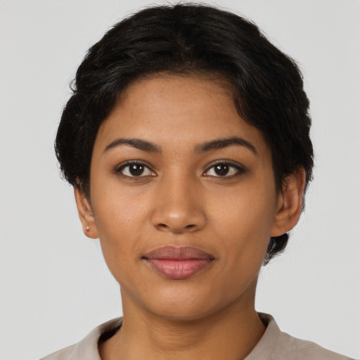 Joyful latino young-adult female with short  brown hair and brown eyes