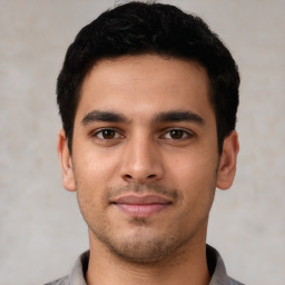 Joyful latino young-adult male with short  black hair and brown eyes