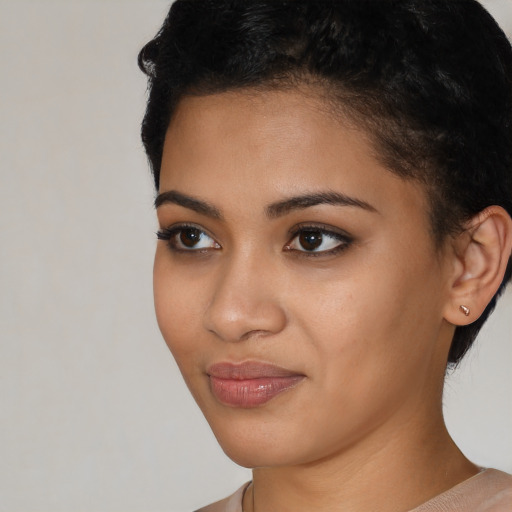Joyful latino young-adult female with short  black hair and brown eyes