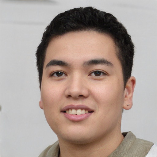 Joyful white young-adult male with short  black hair and brown eyes