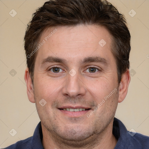 Joyful white adult male with short  brown hair and brown eyes