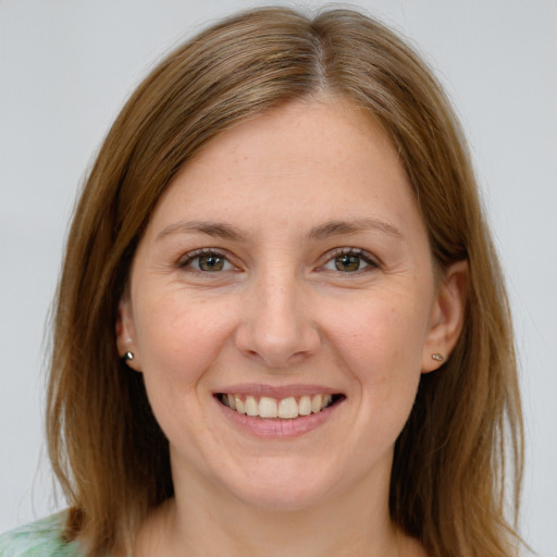 Joyful white young-adult female with medium  brown hair and blue eyes