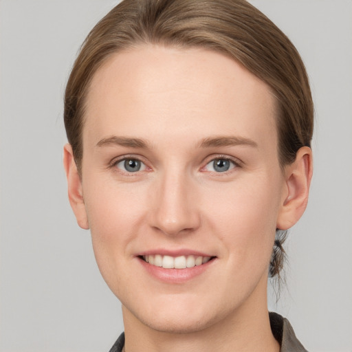 Joyful white young-adult female with short  brown hair and grey eyes