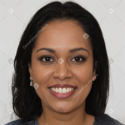 Joyful black young-adult female with long  brown hair and brown eyes