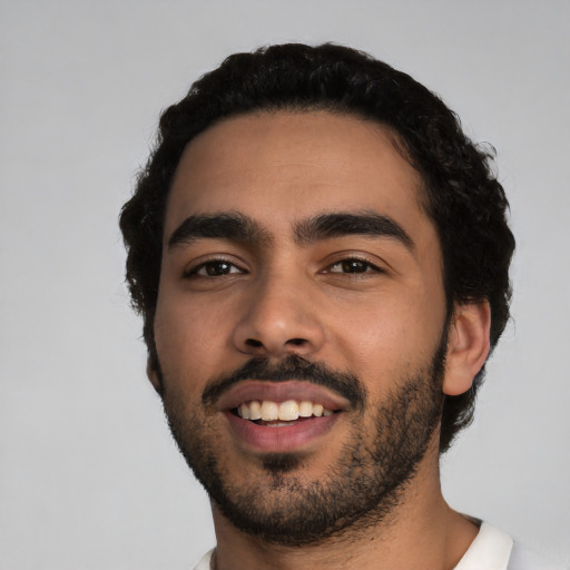 Joyful latino young-adult male with short  black hair and brown eyes