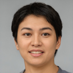 Joyful asian young-adult female with short  brown hair and brown eyes