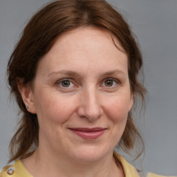 Joyful white adult female with medium  brown hair and brown eyes