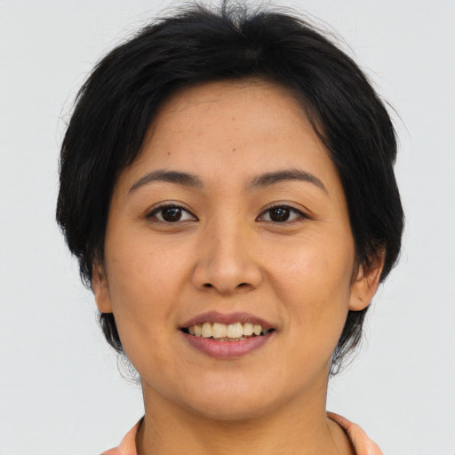 Joyful asian young-adult female with medium  black hair and brown eyes